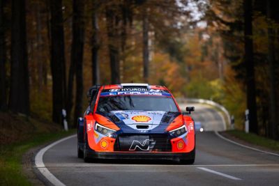 The Hyundai i20 N WRC rally race car speeding down a road.