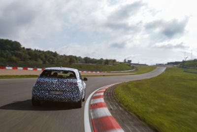 The all-electric Hyundai IONIQ 5 N driving on the at the Nürburgring racetrack.