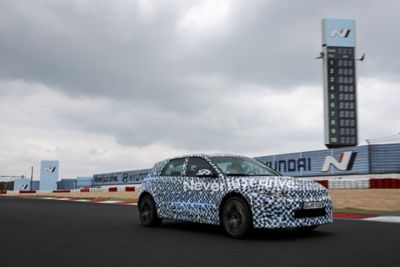 The all-electric Hyundai IONIQ 5 N in camouflage colours at the Nürburgring racetrack.