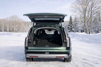 IONIQ 9 varebil i ett vinterlandskap med åpen bagasjeluke. Foto.