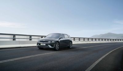 Three-quarter view of new Hyundai IONIQ 5 N Line in dark grey driving along a road.