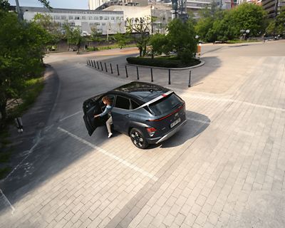 A man standing next to a Hyundai IONIQ