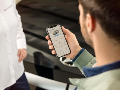 Hyundai customer checking his MyHyundai app on smartphone