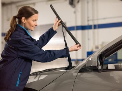 Employee installs new windshield wipers.