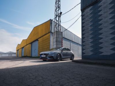 Hyundai i30 Fastback N in an industrial warehouse setting.