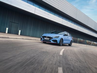 The Hyundai i30 N performance hatchback in Performance Blue, slicing through a curve.