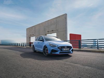 The Hyundai i30 N on a street in performance blue.