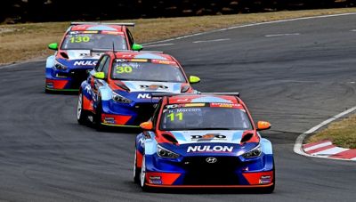 Hyundai TCR cars going down a race track.