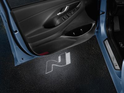 Geöffnete Fahrertür eines Hyundai N Modells mit N-Logo Projektion auf dem Boden.