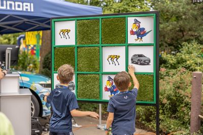 Zwei Kinder stehen vor einer Hyundai Spieltafel im LEGOLAND® Deutschland Resort.