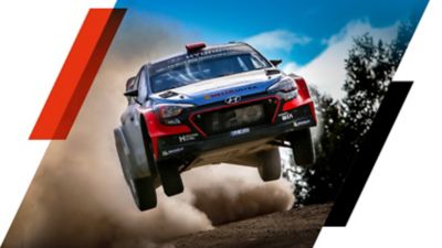 The Hyundai i20 WRC car getting airborne during a rally.