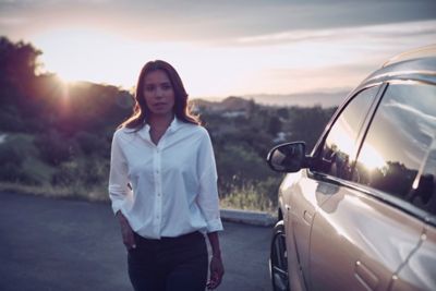 Women standing next to a Hyundai NEXO FCEV parked on a country road.