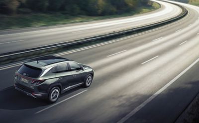 Hyundai TUCSON on a highway from the rear.