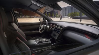 Interior of the all-new Hyundai Tucson Hybrid compact SUV with a person driving.