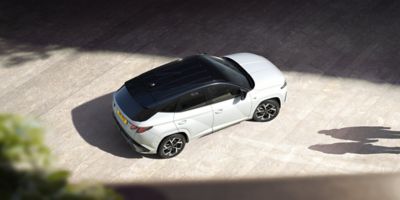 The Hyundai TUCSON Plug-in Hybrid pictured from above parked in the street. 