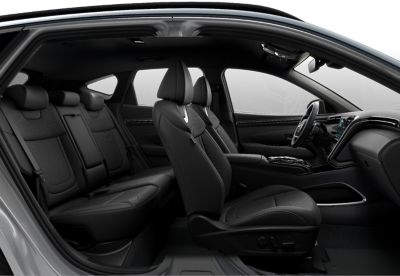 Interior of the Hyundai Tucson Hybrid compact SUV seen from the side.