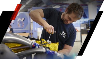 A Hyundai service employee working on a Hyundai model.