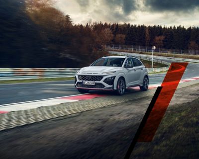 The Hyundai KONA N speeding down a racetrack: Never just drive.	