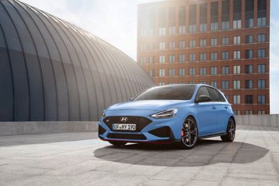 The Hyundai i30 N in blue parked on top of a building.