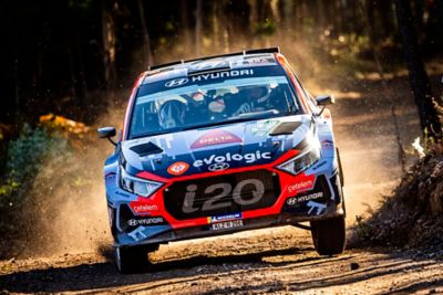 Hyundai i20 N Rally2 racing on a forest road