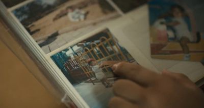 Close-up of a finger pointing at a childhood photo of paralympic athlete Jun-beom Park