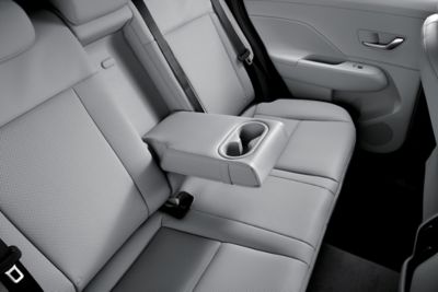 A fold-down armrest with an integrated cup holder in the middle seat of the all-new Hyundai KONA.