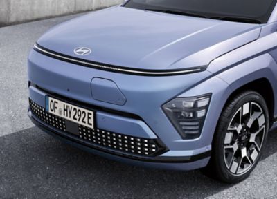 The Hyundai KONA Electric in white with its active air flap in the front.