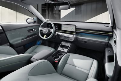 Das vordere Interieur eines Hyundai KONA mit hellgrauer Polsterung und Ambiente-Beleuchtung. 