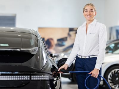Woman charging an IONIQ 6