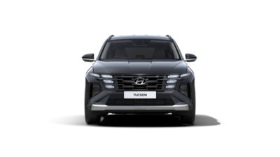 The new Hyundai TUCSON seen from the front, with urban housing in the background.