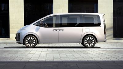  The Hyundai STARIA Hybrid Van shown from the side.