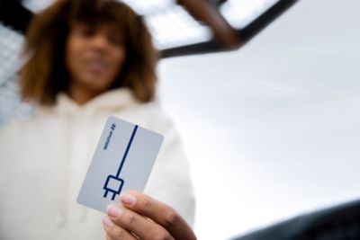 Woman holding her Charge myHyundai card.