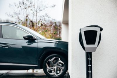 A Hyundai electric vehicle driving into a garage thanks to the purchase incentives for EVs.