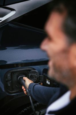 A man charging the Hyundai TUCSON Plug-in Hybrid.