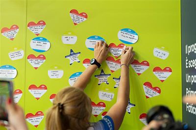 Hyundai mechanic inspecting the underside of a vehicle near the tire.