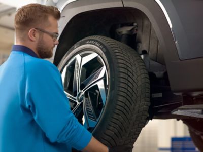 Hyundai technician handling a tyre