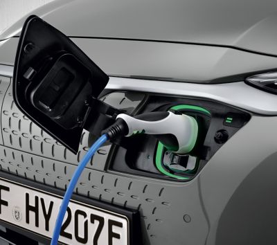 Charging socket of the Hyundai KONA Electric with a plugged in charging cable type 2