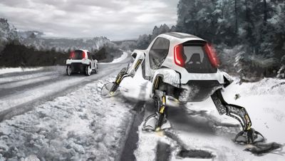 Elevate walking car equipped with snow shoes navigating a snowy environment.