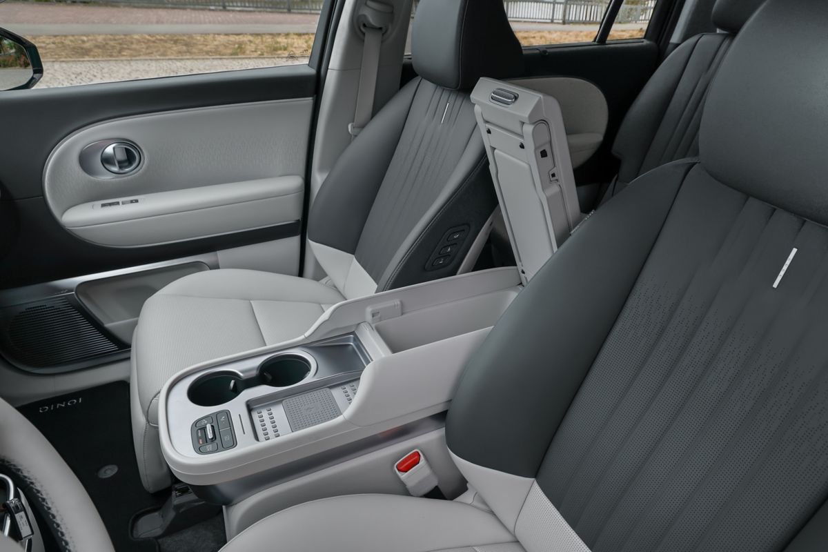 IONIQ 9 cabin showing dual 12.3-inch curved displays and physical climate controls
