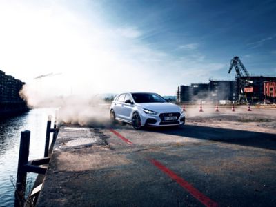 a Hyundai i30 N throwing up dust in a turn