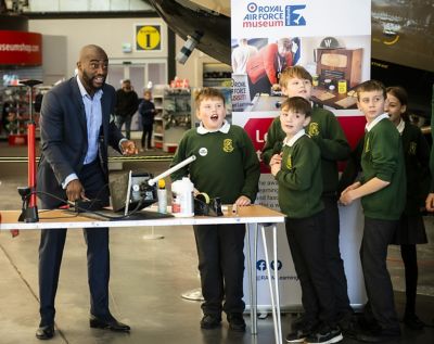 Tim Campbell conducting a physics experiment with school children.