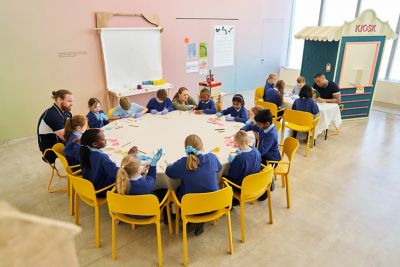 School children sat around a table working on a an activity.