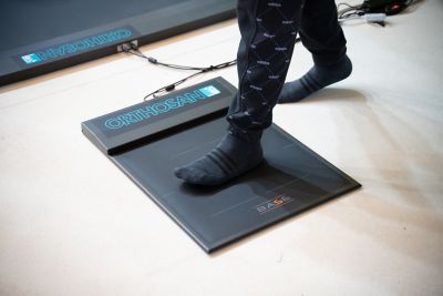 Hyundai mechanic inspecting the underside of a vehicle near the tire.