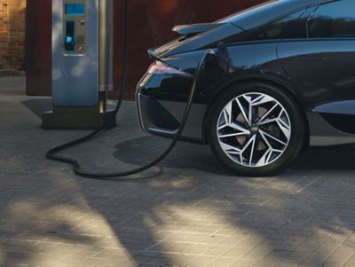 Hyundai IONIQ 6 all-electric saloon plugged into a charging station.