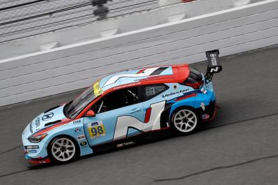  A picture of Hyundai Motorsport’s i30 Veloster N TCR in action on a racetrack shown from above.