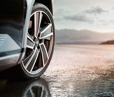 Tyre mounted on a Hyundai wheel on wet surface.