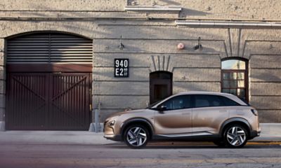 Side view of the Hyundai Nexo driving on a street.