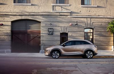 The Hyundai Nexo parked on a city street, side view.