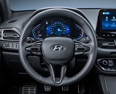 Interior of the N Line in the driver seat, showing the dashboard with the 7-inch display and the leather steering wheel. 