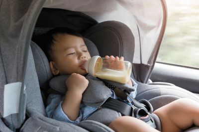 A baby sitting in the Hyundai TUCSON Plug-in Hybrid CUV with its rear occupant alert.